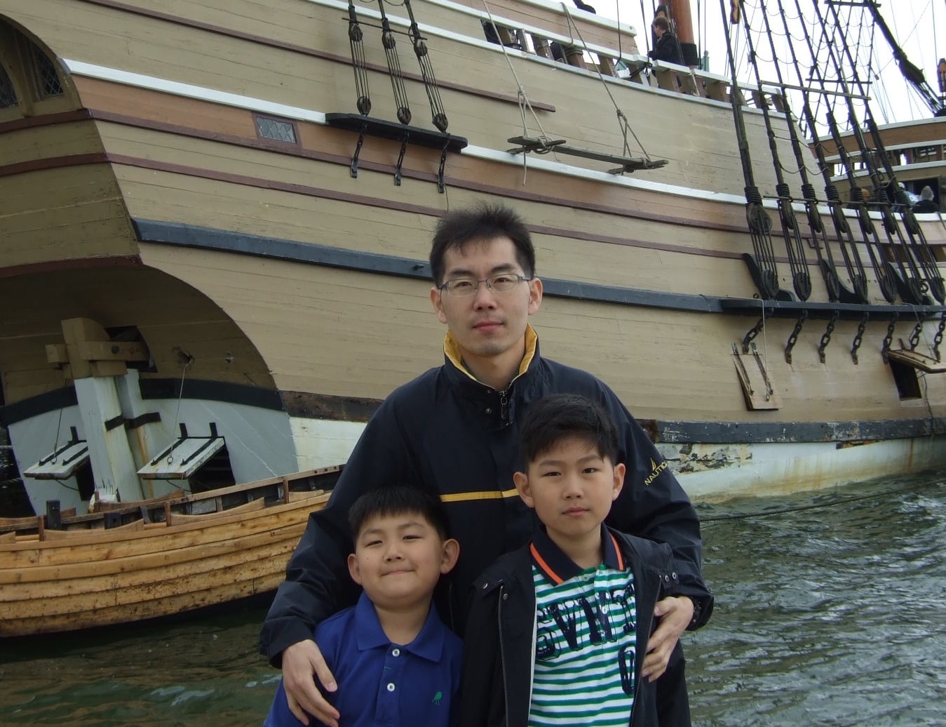 Dad and sons in front of Plymouth